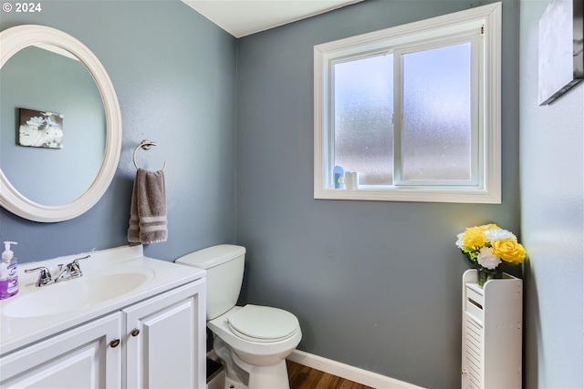 bathroom featuring hardwood / wood-style floors, toilet, and vanity