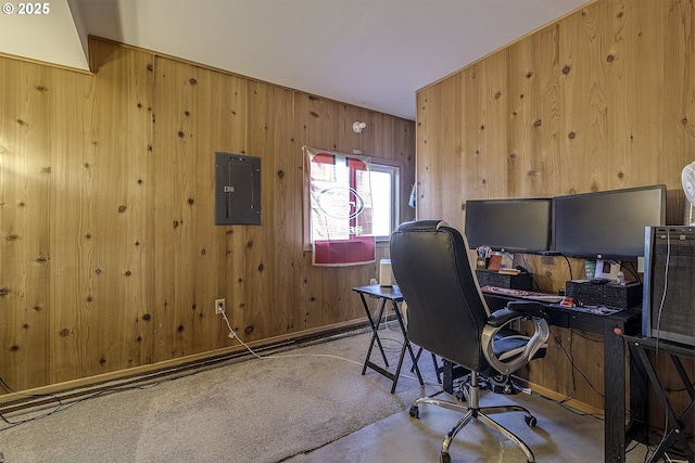 office featuring wood walls, light colored carpet, and electric panel