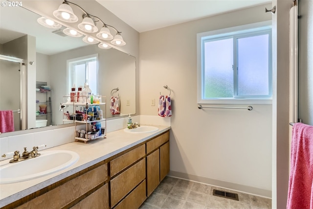 bathroom with a shower with shower door and vanity