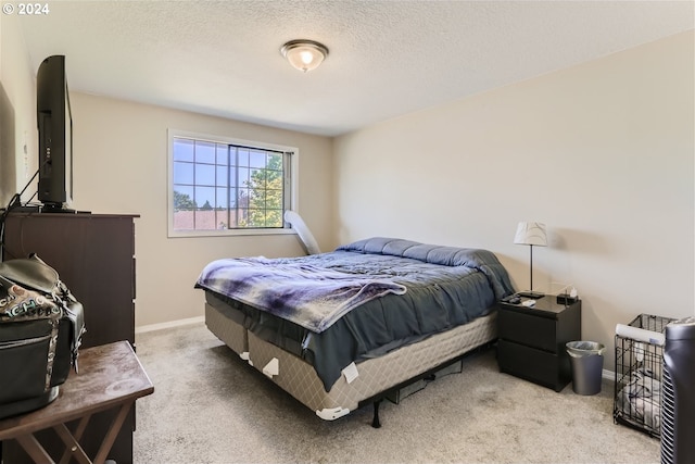 carpeted bedroom featuring a textured ceiling