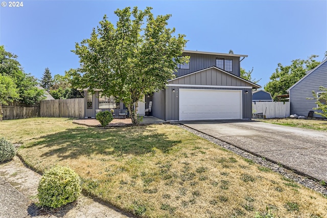 view of front of home featuring a front yard and a garage