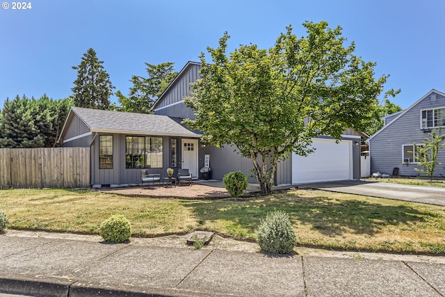 view of front of property featuring a garage and a front lawn