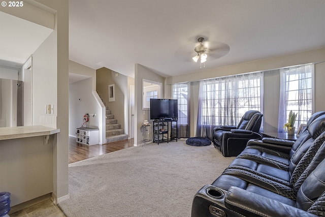 carpeted living room featuring lofted ceiling and ceiling fan