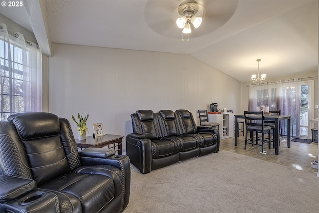 living room with light carpet, ceiling fan with notable chandelier, and lofted ceiling