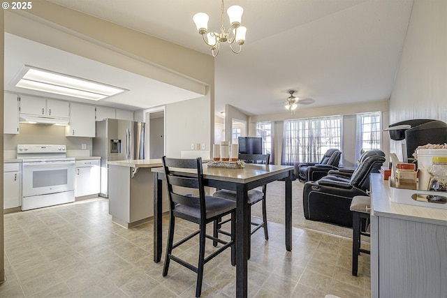 dining room featuring ceiling fan with notable chandelier