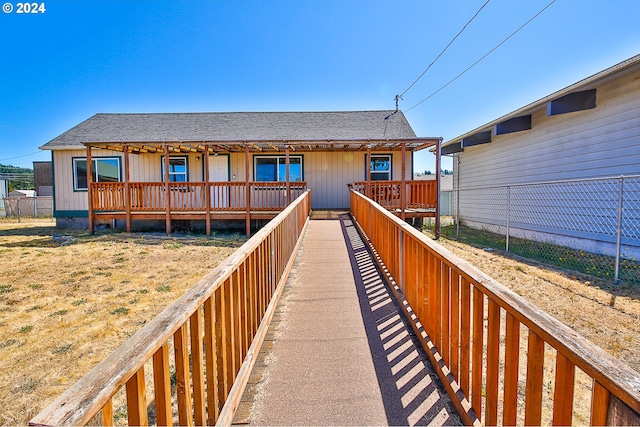 back of property featuring fence and roof with shingles