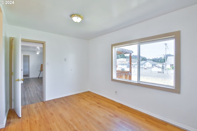 unfurnished room featuring light wood-style floors and baseboards