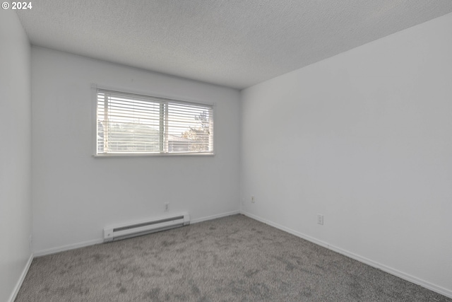 carpeted empty room with a textured ceiling and a baseboard heating unit