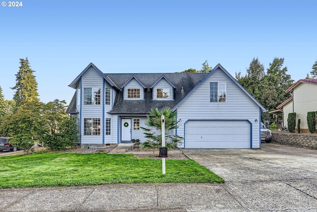 view of front of property featuring a garage and a front yard