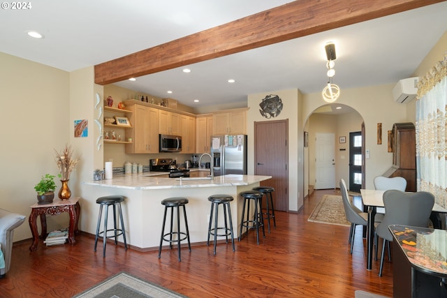 kitchen with a breakfast bar, an AC wall unit, light brown cabinets, kitchen peninsula, and stainless steel appliances