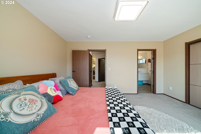 carpeted bedroom with connected bathroom