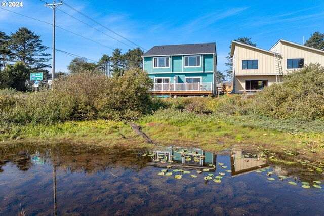 back of property with a water view