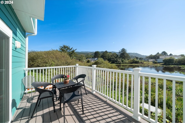 balcony featuring a deck with water view