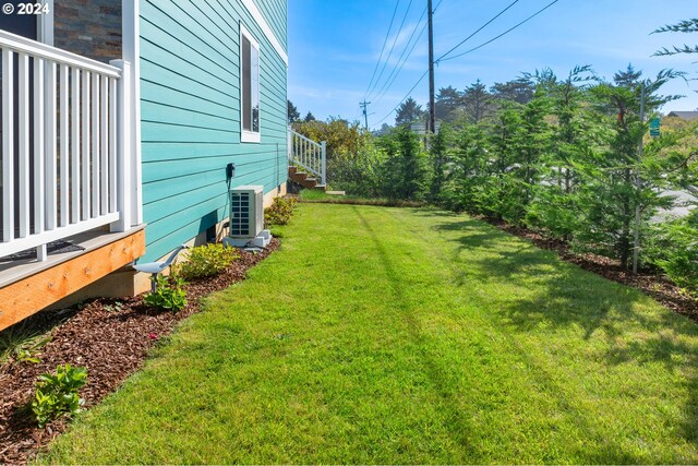 view of yard with central AC unit and ac unit