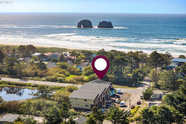 aerial view with a water view and a beach view