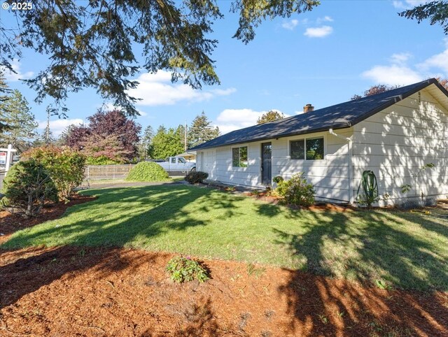 ranch-style house featuring a front yard and a garage