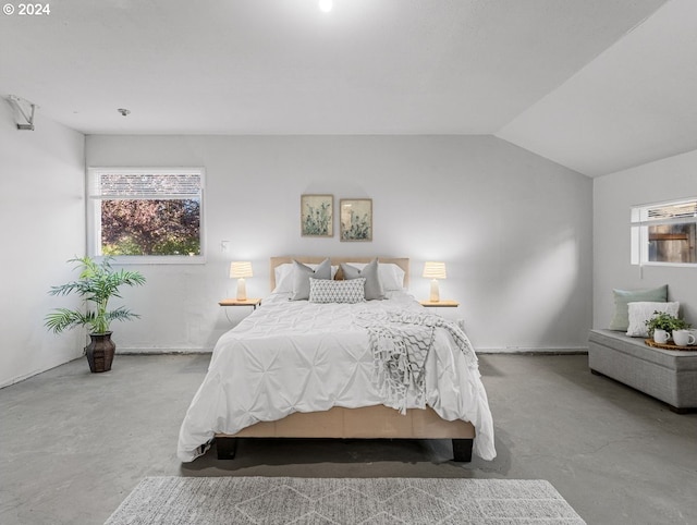 bedroom featuring concrete floors and vaulted ceiling