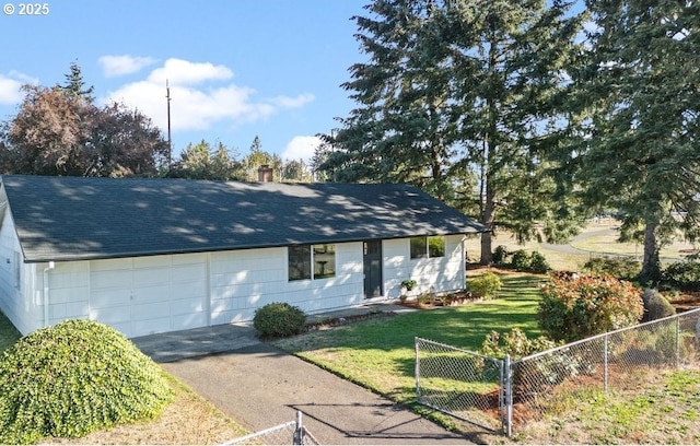 single story home with a shingled roof, aphalt driveway, fence private yard, a front yard, and a garage