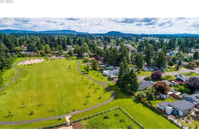 birds eye view of property featuring a mountain view and a view of trees