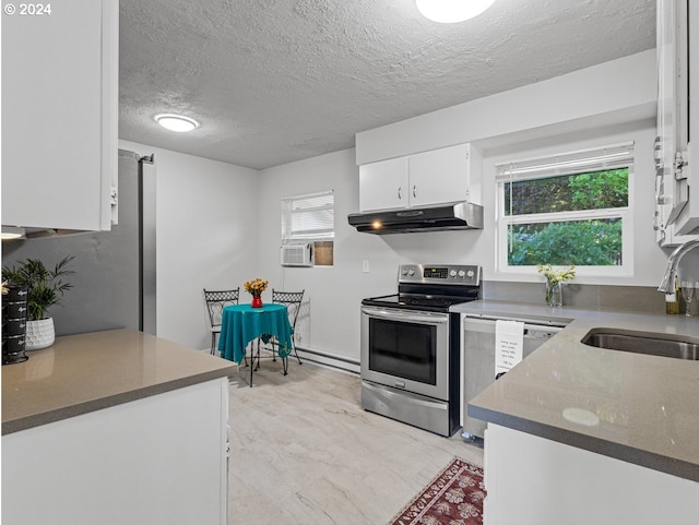 kitchen featuring a textured ceiling, stainless steel appliances, sink, white cabinetry, and plenty of natural light