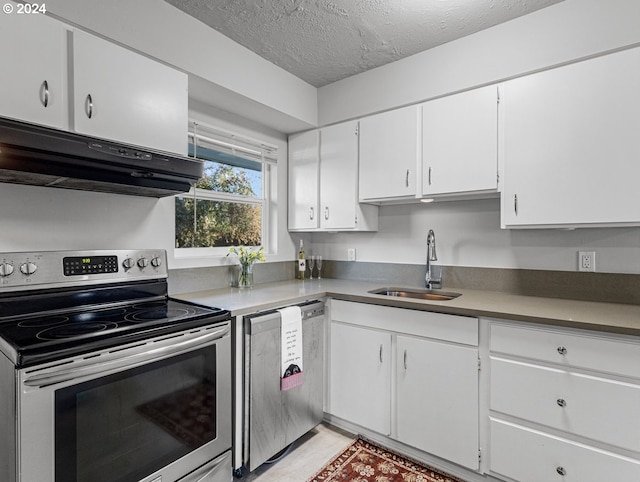 kitchen with exhaust hood, white cabinetry, sink, and appliances with stainless steel finishes