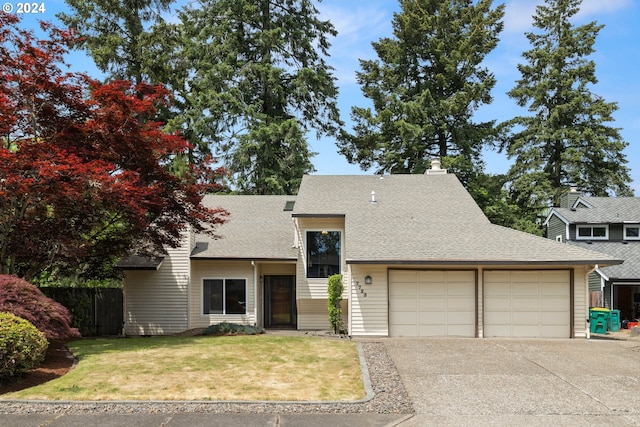 view of front of house with a front yard and a garage