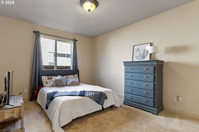 bedroom with light colored carpet