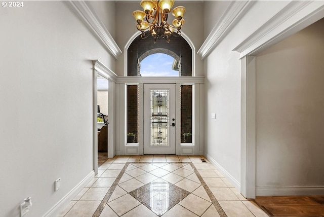 entryway with a notable chandelier and a towering ceiling