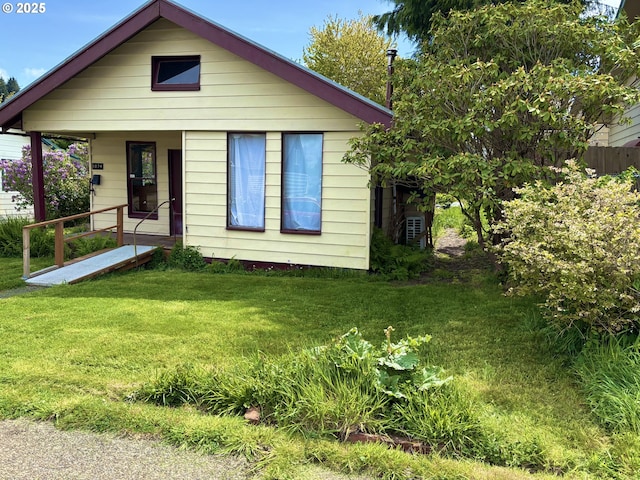 1074 Fir Ave, Reedsport, OR 97467 - bungalow-style home featuring covered porch and a front lawn