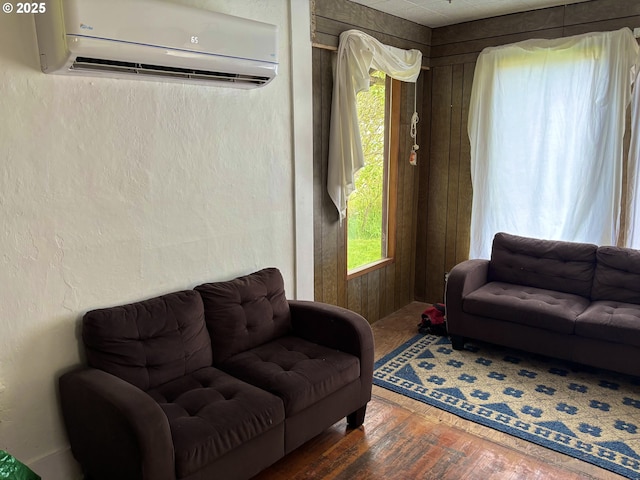 1074 Fir Ave, Reedsport, OR 97467 - living area featuring a wall mounted air conditioner, wood finished floors, and healthy amount of natural light