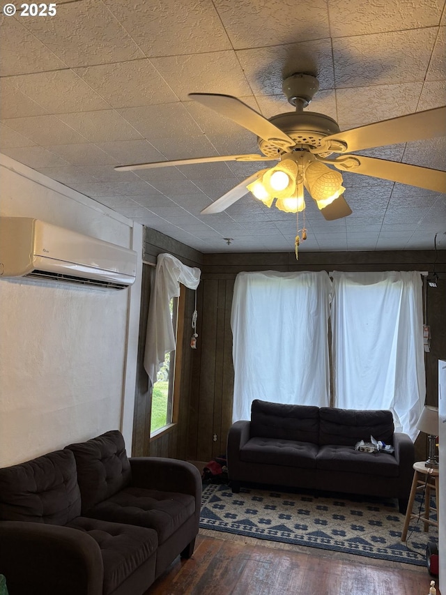 1074 Fir Ave, Reedsport, OR 97467 - living area featuring a wall unit AC, plenty of natural light, hardwood / wood-style floors, and a ceiling fan
