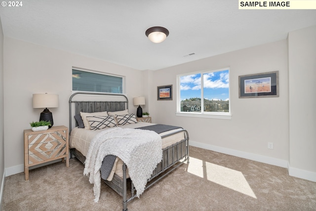 bedroom featuring light carpet