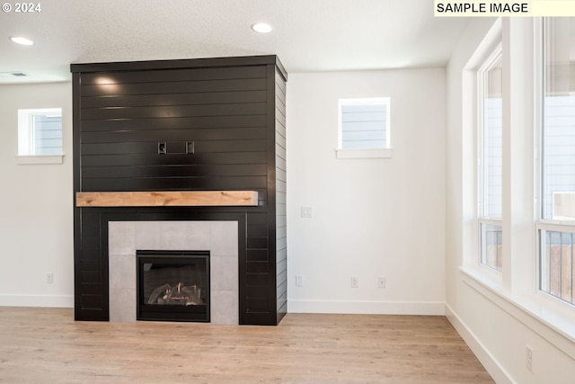 details featuring hardwood / wood-style flooring and a fireplace