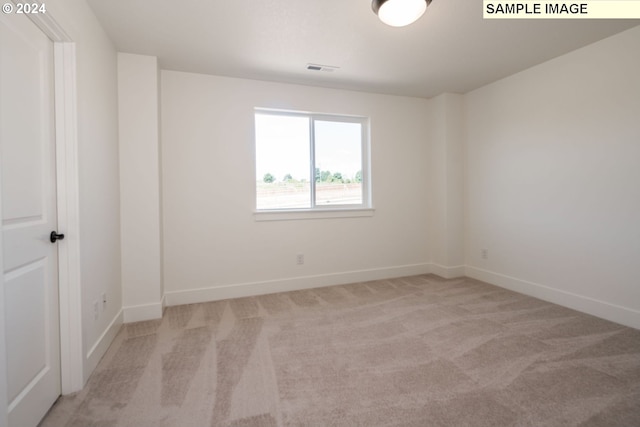 empty room featuring light carpet