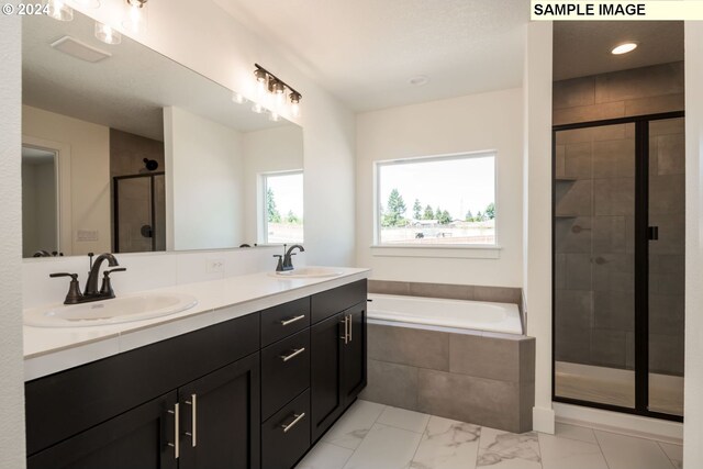 bathroom with vanity and plus walk in shower