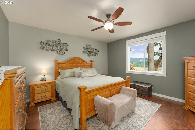 bedroom with ceiling fan and dark wood-type flooring