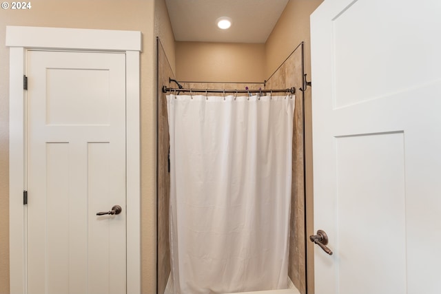 bathroom featuring a shower with curtain and a textured ceiling