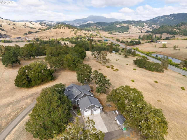 drone / aerial view featuring a rural view and a water and mountain view