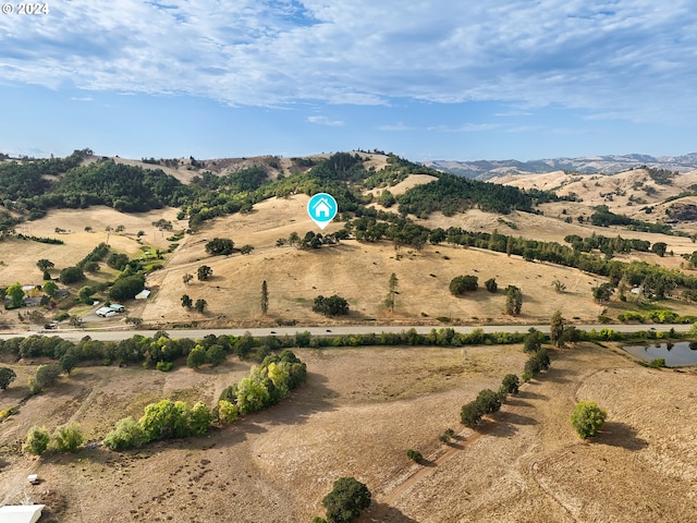 drone / aerial view featuring a mountain view and a rural view