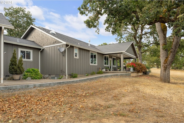 rear view of property with covered porch