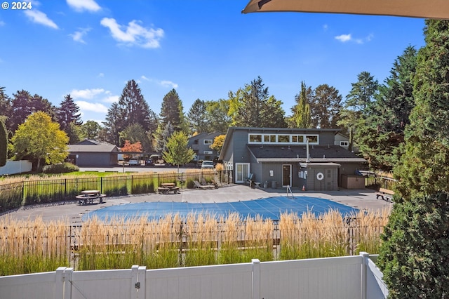 view of swimming pool featuring a patio area and a fire pit