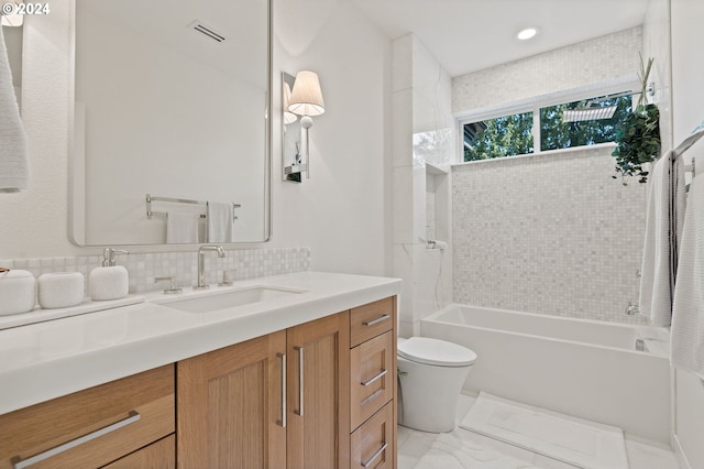 full bathroom with tasteful backsplash, vanity, toilet, and tiled shower / bath