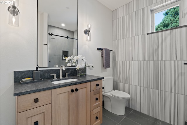 bathroom with vanity, toilet, tile patterned floors, and an enclosed shower