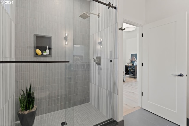 bathroom featuring walk in shower and hardwood / wood-style floors