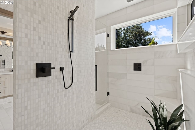 bathroom featuring vanity, tile patterned floors, and a shower with shower door