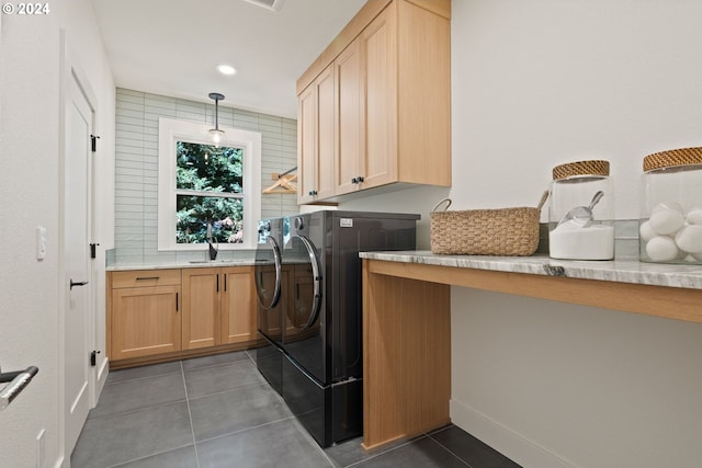 laundry area with cabinets, sink, independent washer and dryer, and dark tile patterned floors