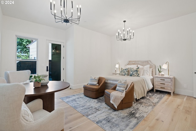 bedroom featuring light wood-type flooring and a chandelier