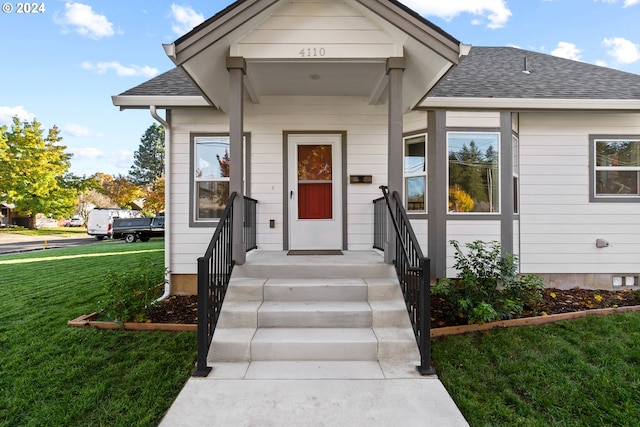 doorway to property featuring a lawn