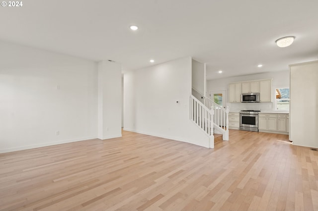 unfurnished living room with light hardwood / wood-style flooring