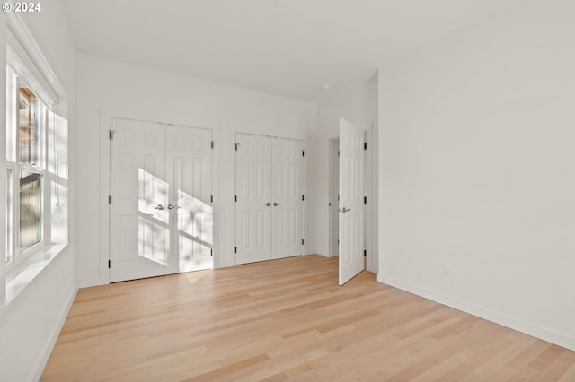 unfurnished room with light wood-type flooring